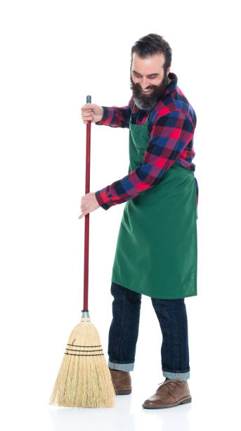 istock Male person with an apron and a broom 927262918