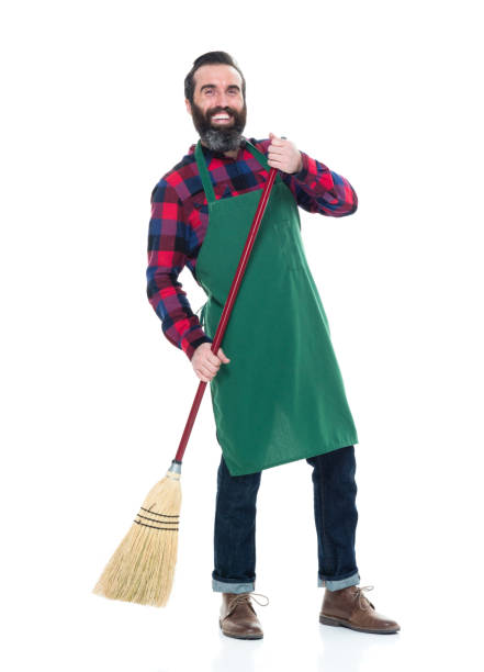 istock Male person with an apron and a broom 927263064