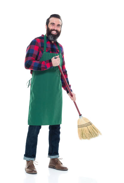 istock Male person with an apron and a broom 927263206