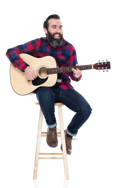 istock Handsome singer songwriter sitting on stool 927264104