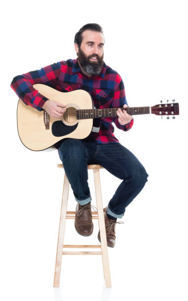 istock Handsome singer songwriter sitting on stool 927264112