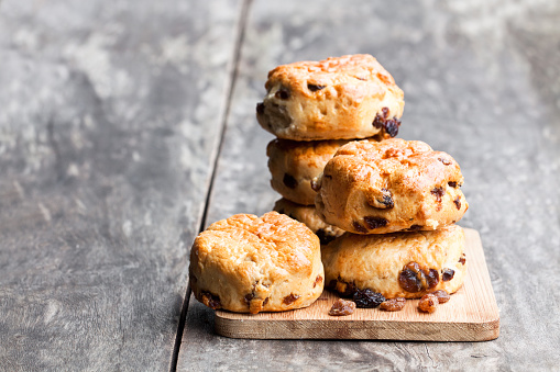 Homemade  sultana scones on wooden table