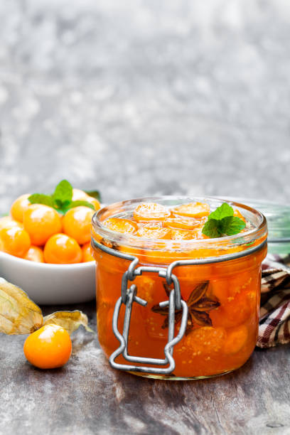 istock Homemade  physalis jam in jar on wooden table 927271116