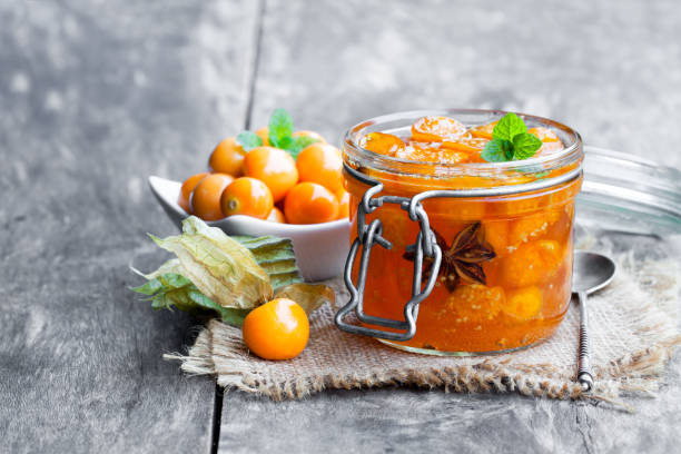 istock Homemade  physalis jam in jar on wooden table 927271344