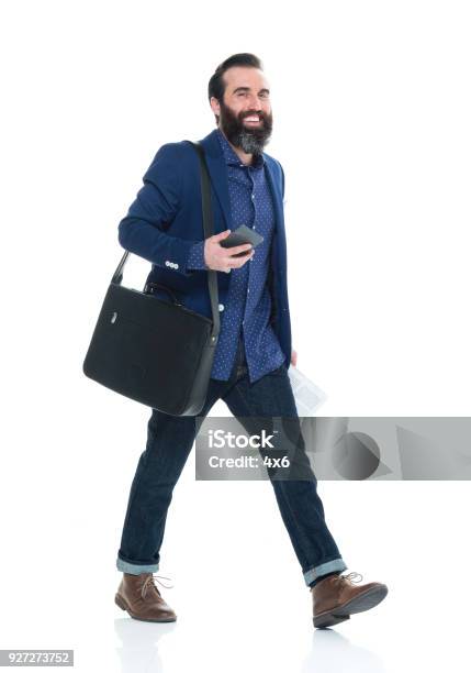 Man With Beard Holding Bag And Phone And Walking Stock Photo - Download Image Now - Walking, Cut Out, White Background