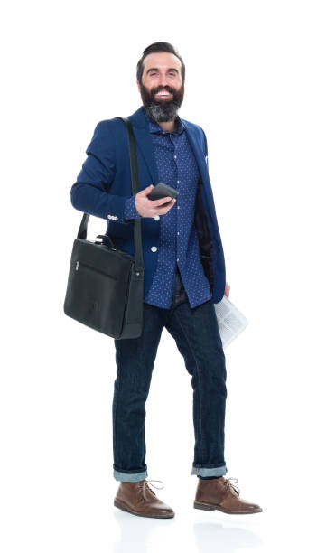istock Man with beard holding bag and phone and walking 927273766
