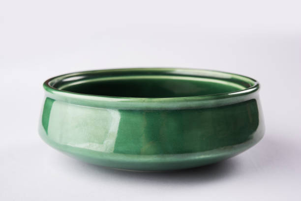 Empty green ceramic serving bowl, isolated over white or gray background