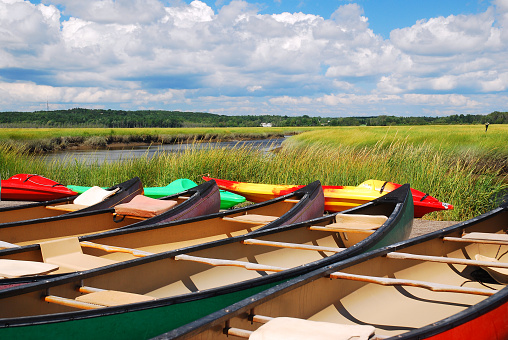 Canoes are ready to head out on the next adventure at a salt marsh in Maine