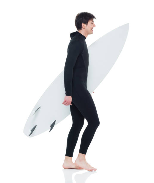 istock Young handsome male surfer walking 927277142
