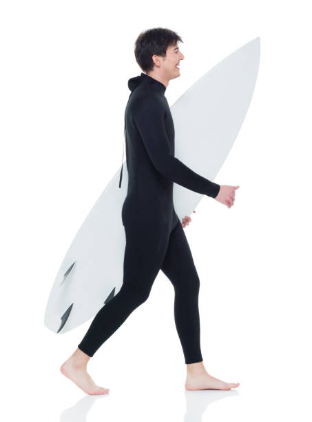 istock Young handsome male surfer walking 927277212