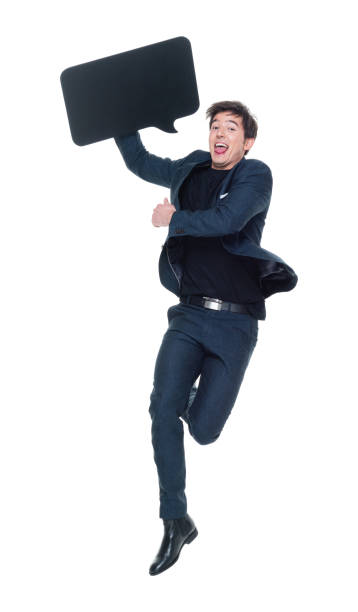 istock Attractive man in business clothes jumping and holding speech bubble 927277464
