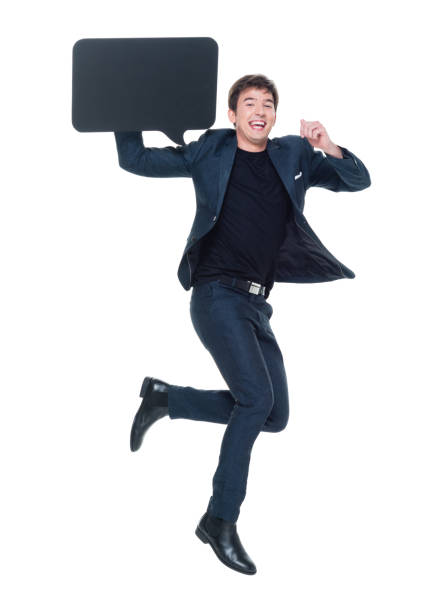 istock Attractive man in business clothes jumping and holding speech bubble 927277536