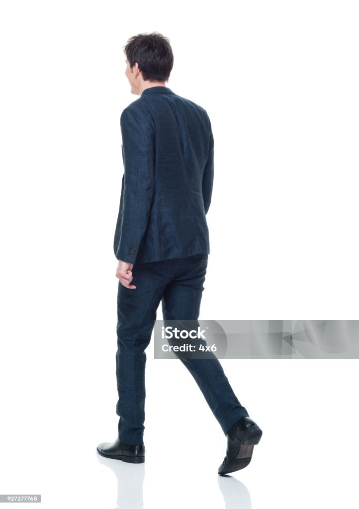 Handsome young adult male in business attire walking Handsome young adult male Walking Stock Photo