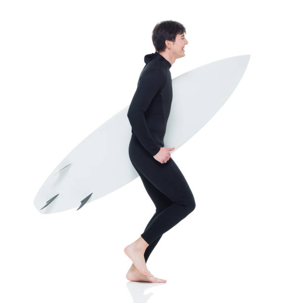 istock Young handsome male surfer running 927277914