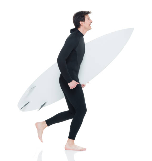 istock Young handsome male surfer running 927277962