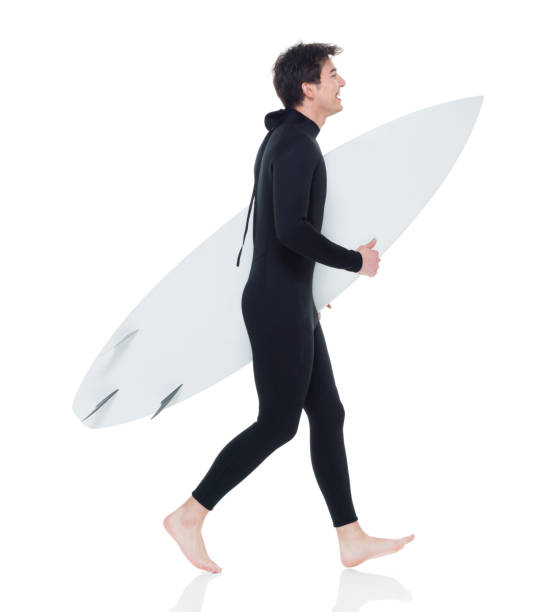 istock Young handsome male surfer running 927277964