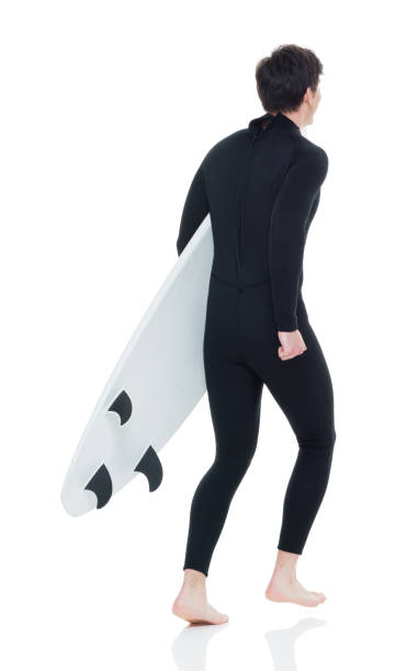 istock Young handsome male surfer running 927280114