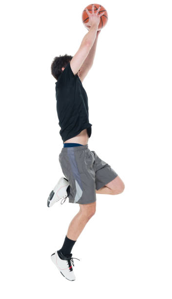 istock Handsome young man with a basketball doing a layup 927280384