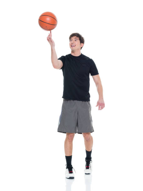 istock Handsome young man spinning a basketball 927283242