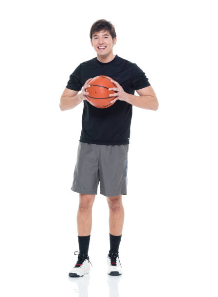 istock Good looking young man holding a basketball 927283338