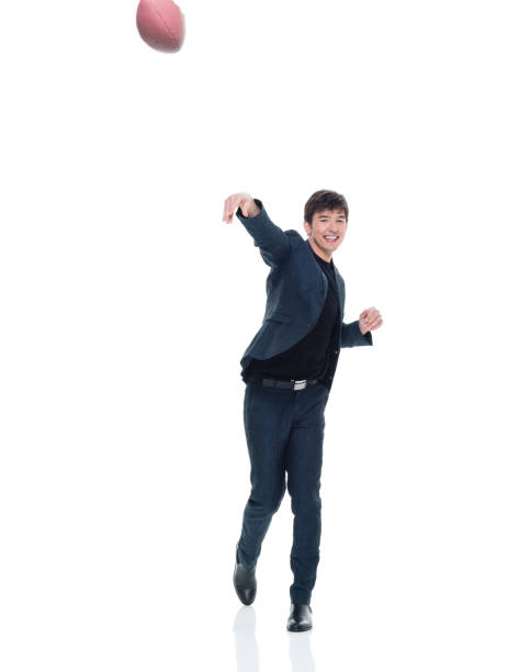 Charming young businessman holding a football