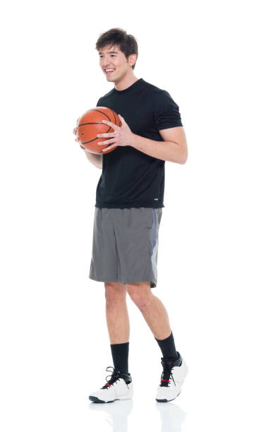istock Good looking young man holding a basketball 927283384