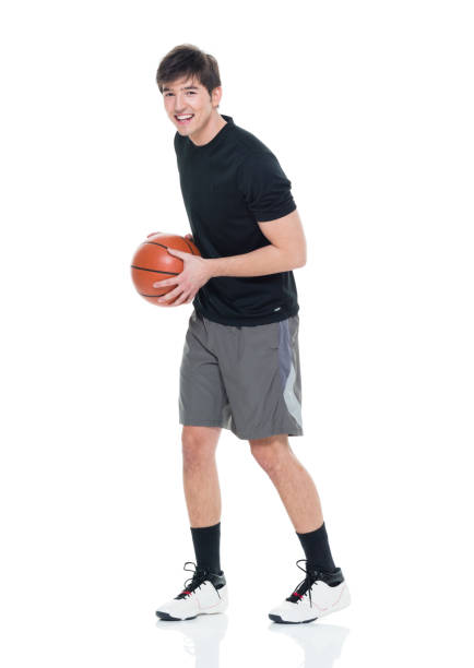 istock Good looking young man holding a basketball 927283498