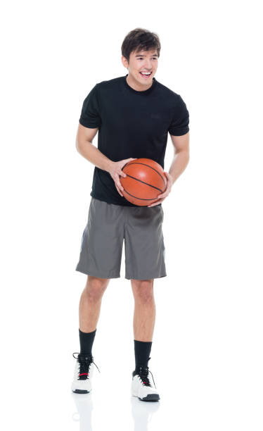 istock Good looking young man holding a basketball 927283544