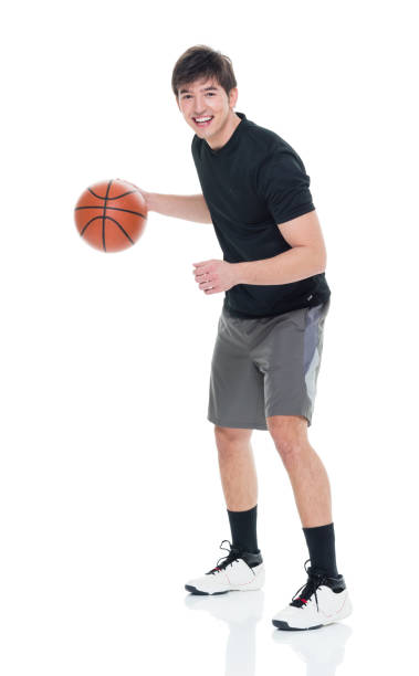 istock Good looking young man playing with a basketball 927283620