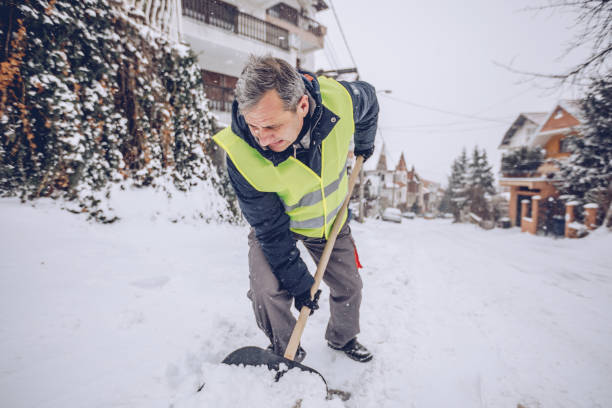 istock Senior man cleaning doorway from snow 927286616