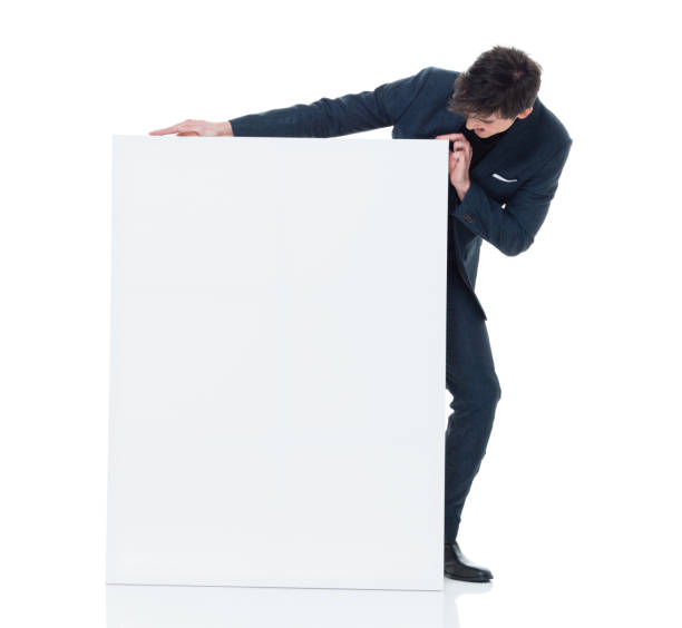 istock Attractive businessman holding a white placard 927286878