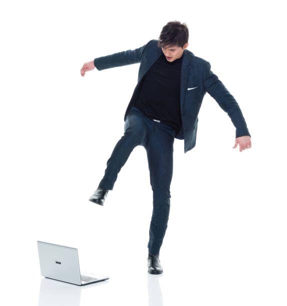 istock Attractive man in business clothes has computer rage 927286952