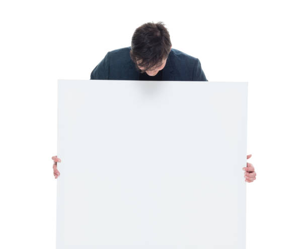 istock Attractive businessman holding a white placard 927286982