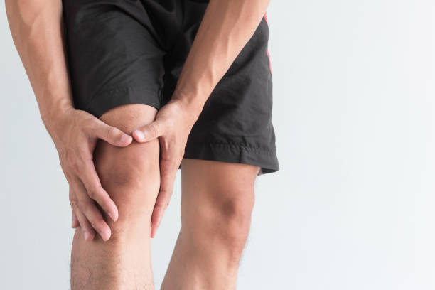 young man with knee pain and copy space stock photo