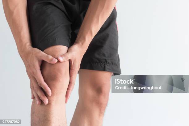 Young Man With Knee Pain And Copy Space Stock Photo - Download Image Now - Knee, Pain, Men