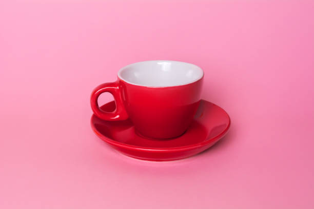 istock Red coffee cup and saucer on a pink background 927293336