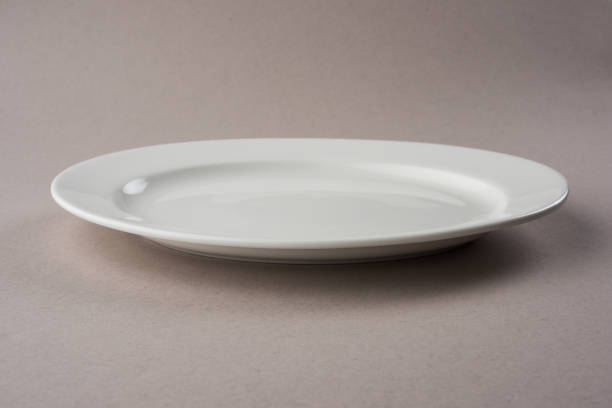 istock Empty white long and oval ceramic plate isolated on white or gray background 927298488