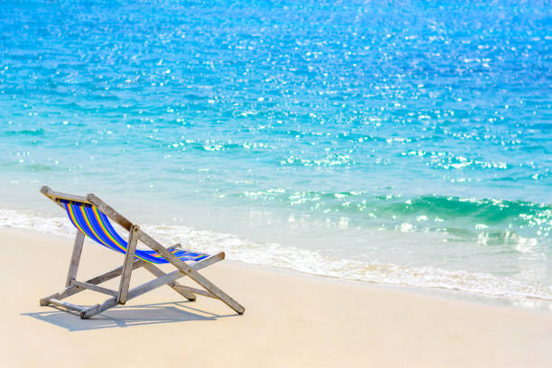 istock A seat on the beach with blue sea background 927303156