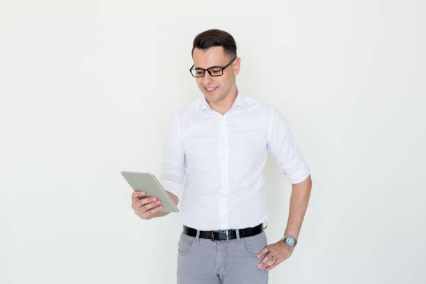 istock Smiling Handsome Business Man Holding Tablet 927309464