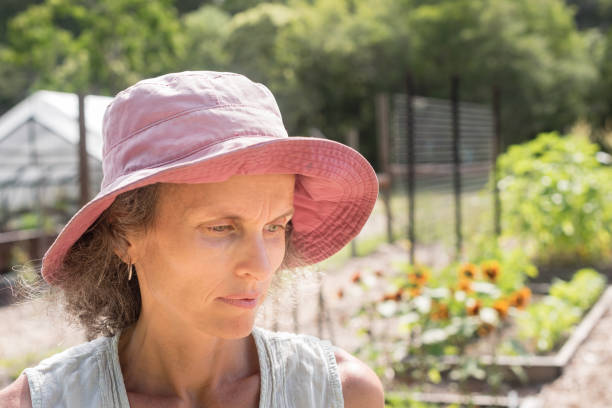 istock Middle aged woman in sunhat in garden 927312514