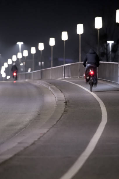 istock 2 cyclists ride at night on a bike path 927313250