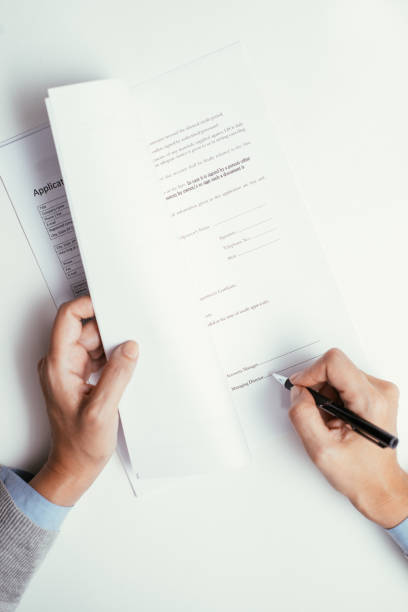 istock Businesswoman signing document after reading 927319660