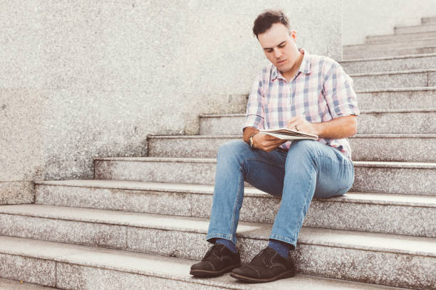 istock Serious Man Making Notes on City Stairway 927320568