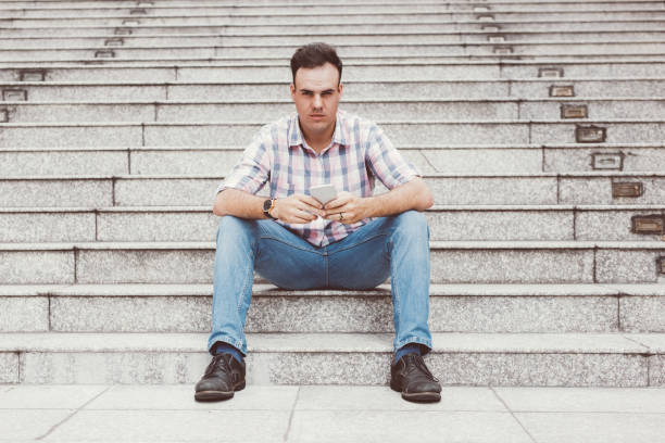 istock Serious Man Using Smartphone on City Stairway 927320588