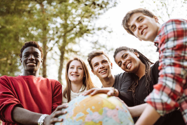 istock friends with globe at the park 927323856
