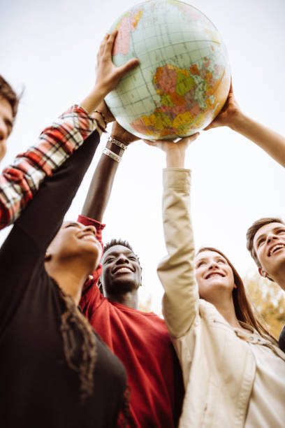 istock friends with globe at the park 927323952