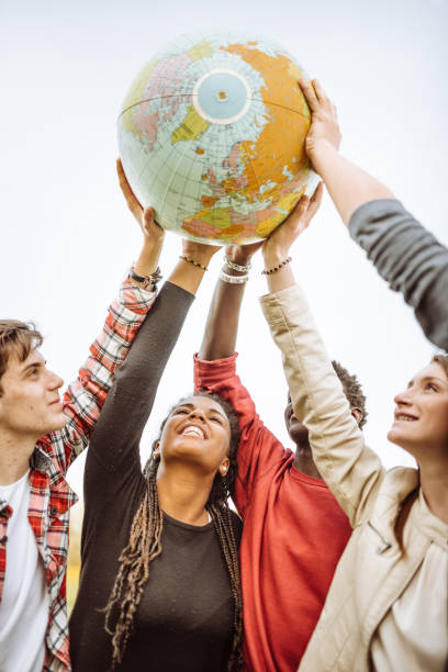istock friends with globe at the park 927323972