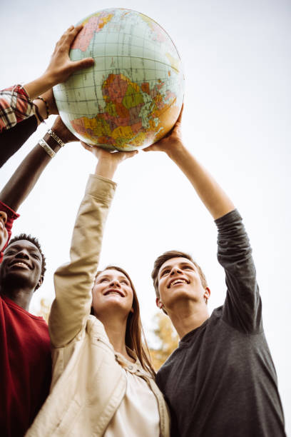 istock friends with globe at the park 927323978