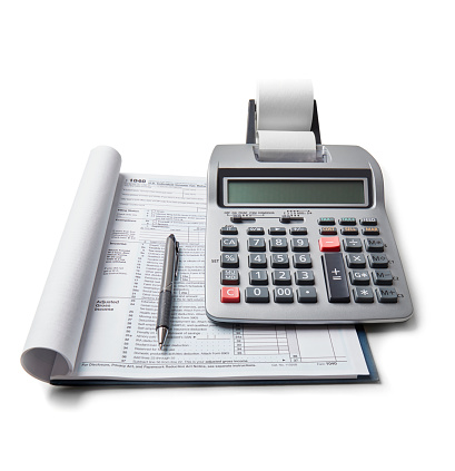 Tax return and calculator on white background