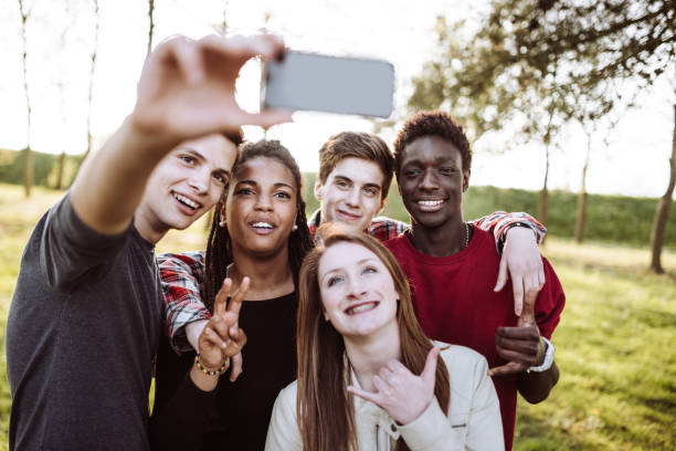 istock friends take selfie in the park 927327244